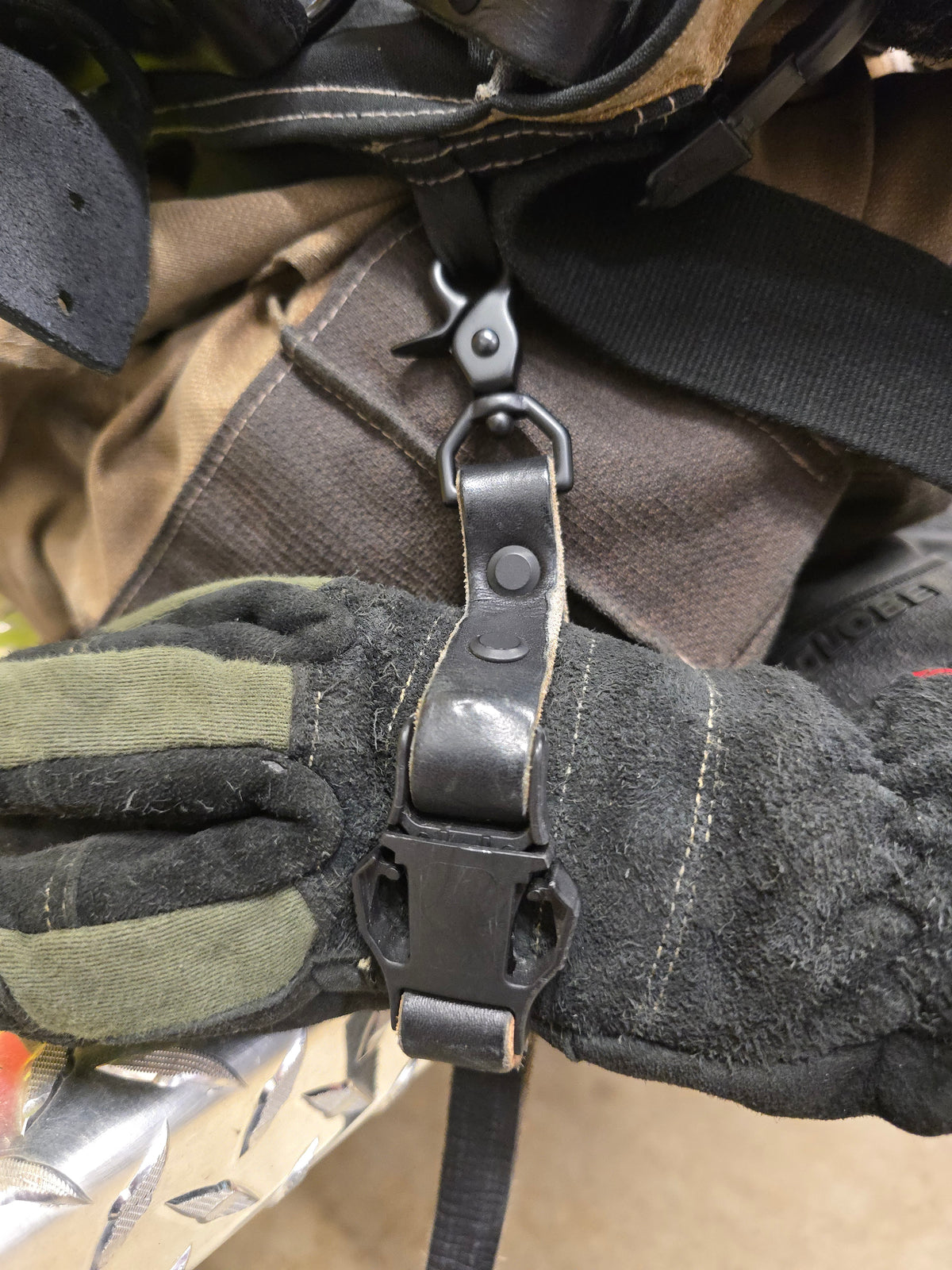 Leather firefighter glove strap, spring clip detail