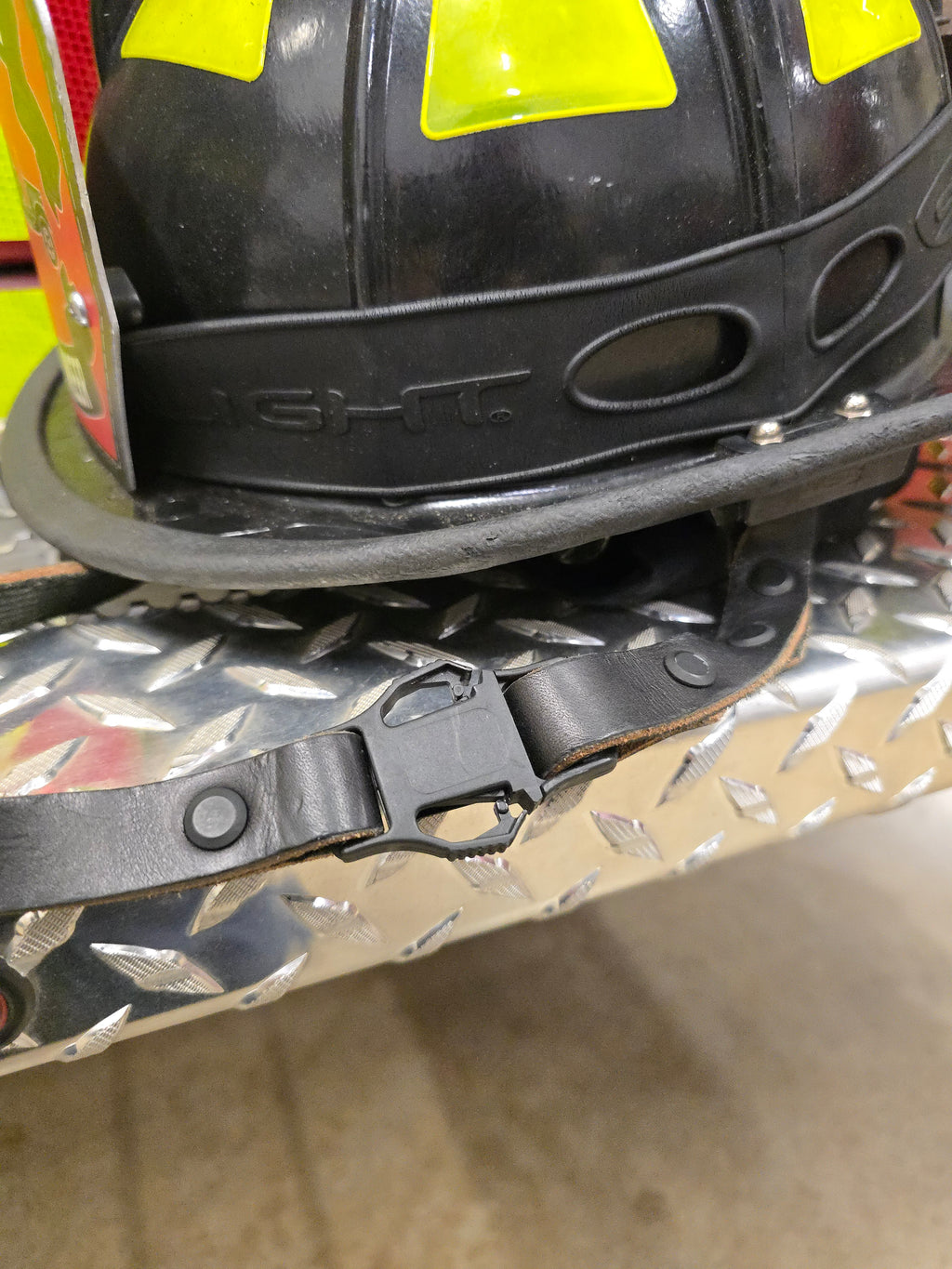 Leather firefighter helmet chin strap, spring clip detail