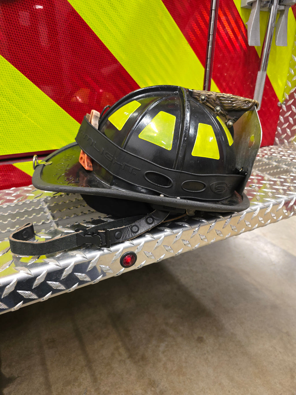 Leather firefighter helmet chin strap, buckle detail