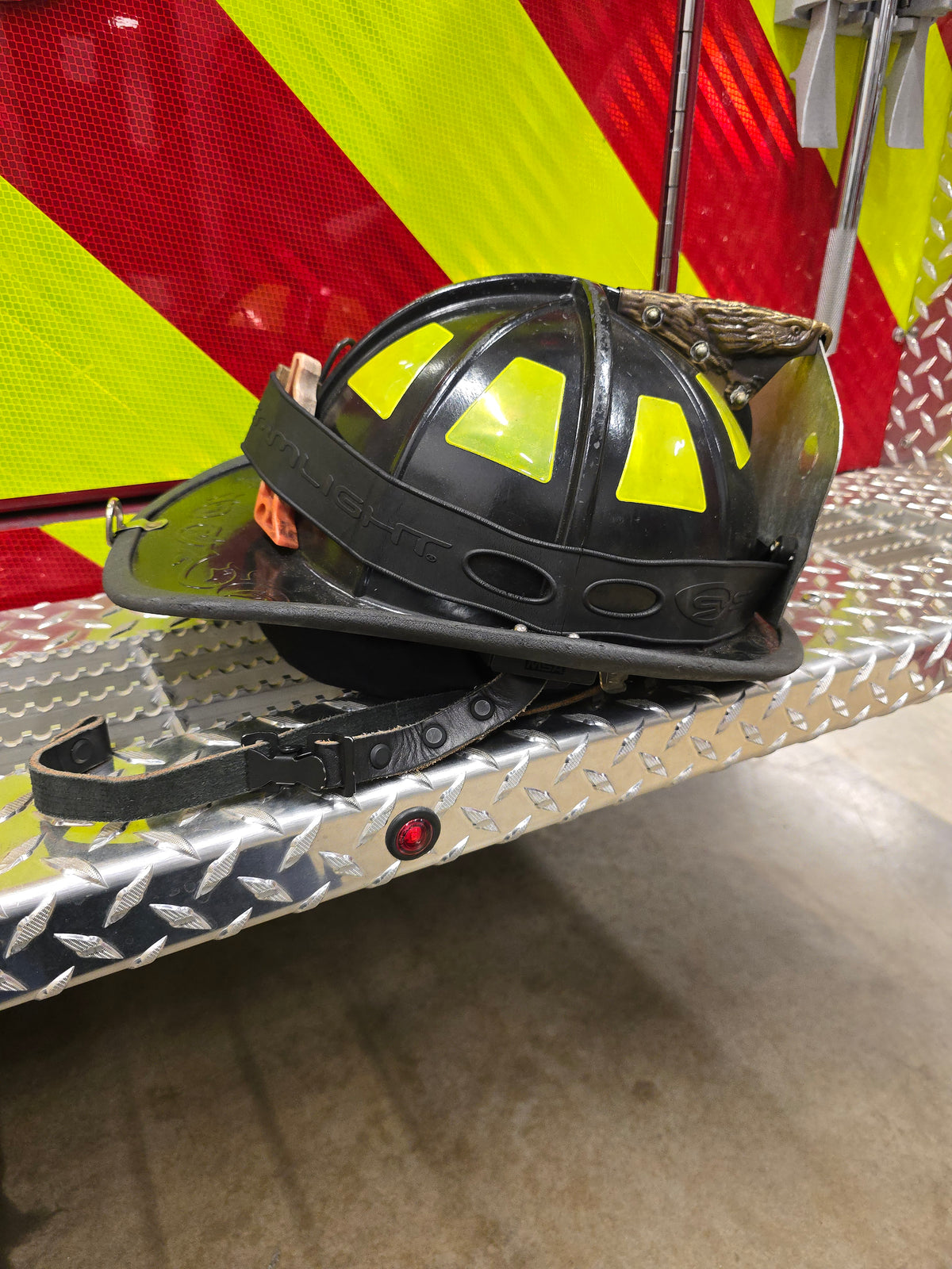 Leather firefighter helmet chin strap, buckle detail