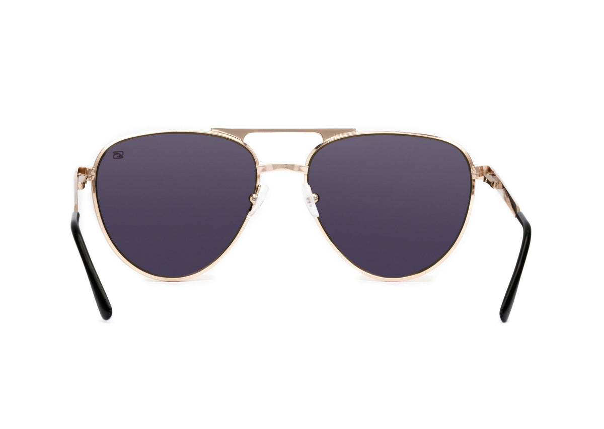 Aviator sunglasses in rose gold with pink lens, case and packaging