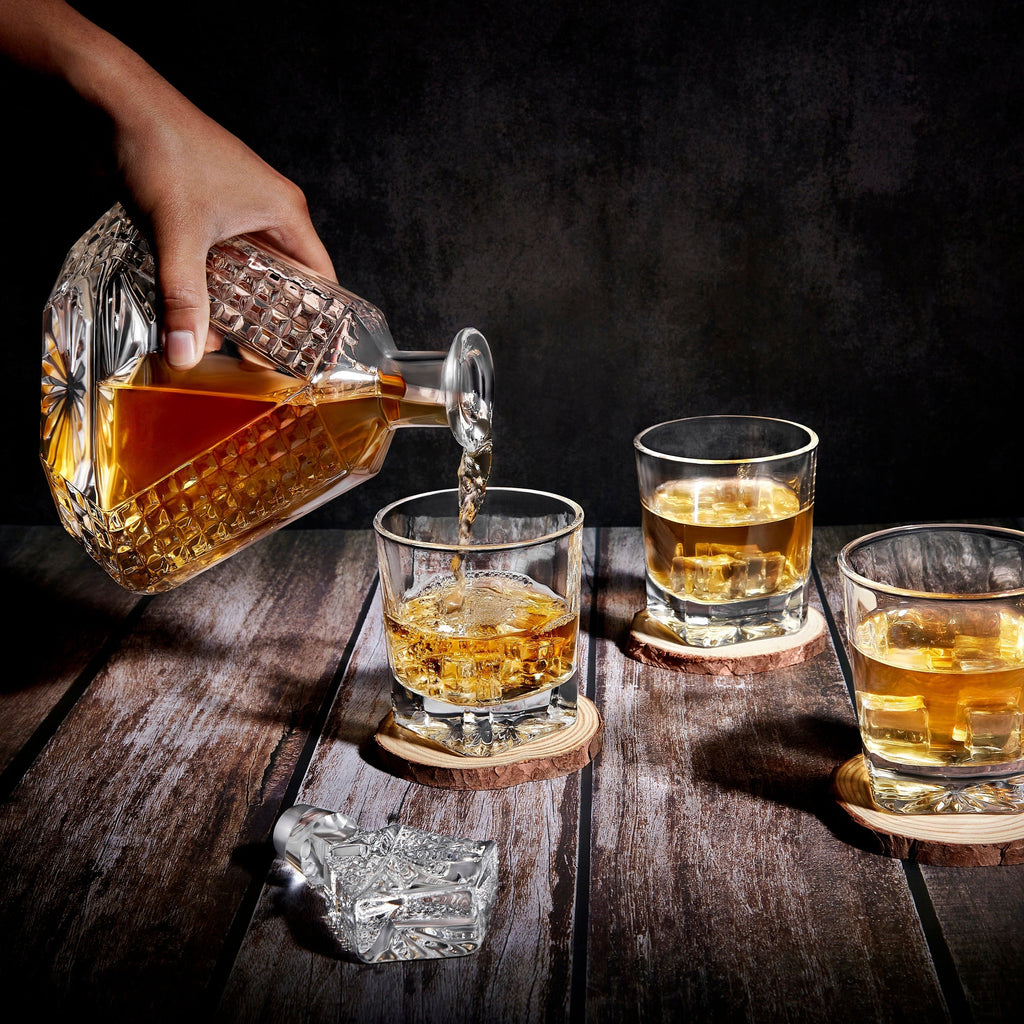 Triangle decanter pouring whiskey into a rocks glass